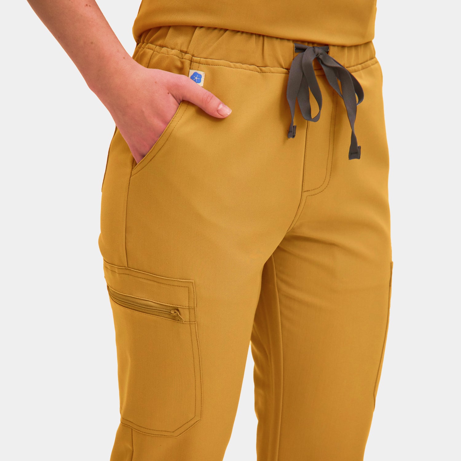 Front view of Allscrubs Women's Mild Cargo Scrub Pants in Amber