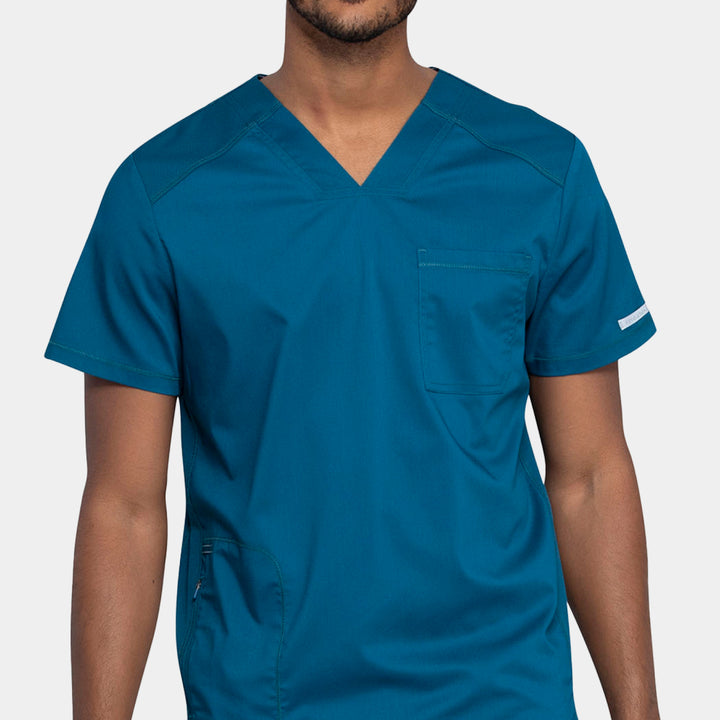 Close-up front view showing neckline and pocket details on Caribbean WW603 men’s v-neck scrub top
