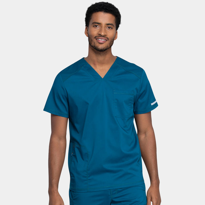 Front view of Cherokee Revolution WW603 men’s v-neck scrub top in Caribbean color