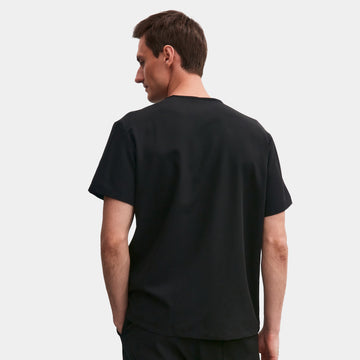 Back view of Allscrubs Men’s Zen Scrub Top in black on model