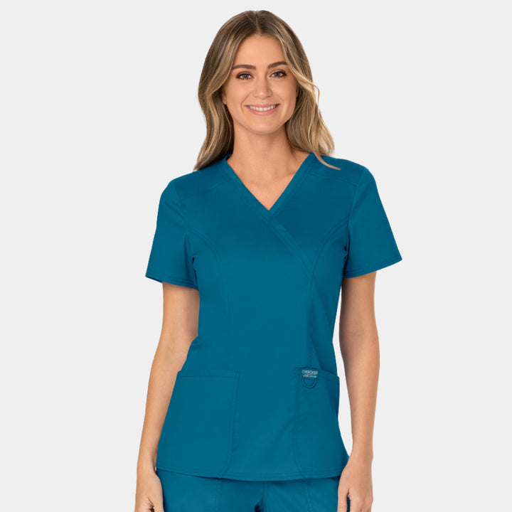 Front view of Cherokee Revolution WW610 women’s mock wrap scrub top in Caribbean