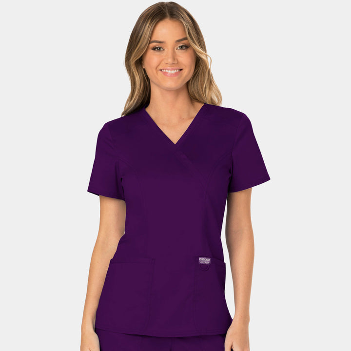 Front view of Cherokee Revolution WW610 women’s mock wrap scrub top in Eggplant