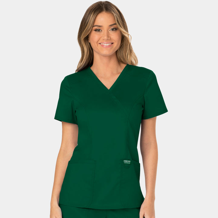 Front view of Cherokee Revolution WW610 women’s mock wrap scrub top in Hunter Green