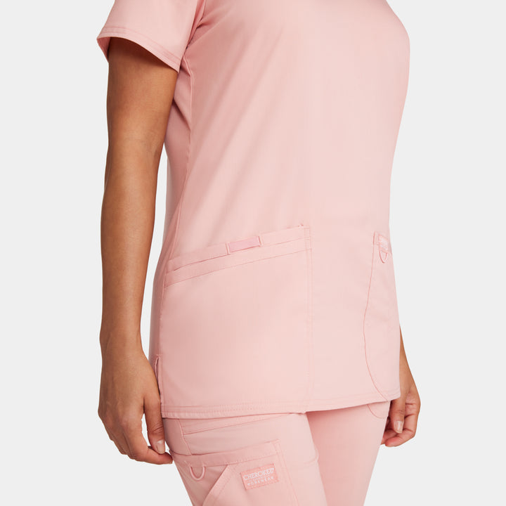 Zoomed-in side view of WW620 women’s v-neck scrub top in Pink Essence